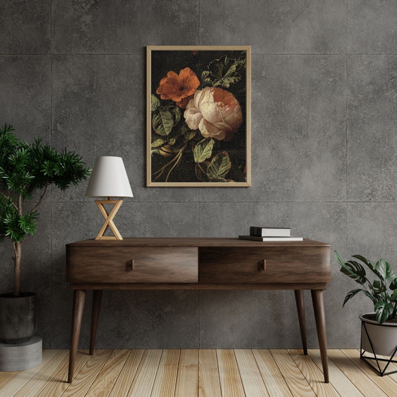 May include: A framed print of a still life featuring a bouquet of pink and orange flowers with green leaves on a dark background.