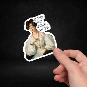 May include: A sticker featuring a woman in a white dress with a gold necklace and bracelets. The sticker has the text "Apparently I have an attitude. Who knew."