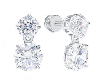 May include: A pair of silver-toned drop earrings featuring two round, clear, faceted stones set in a prong setting. The upper stone is smaller than the lower stone, and the earrings include a secure screw-back post mechanism for attachment.