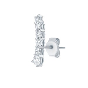 May include: A silver earring with a row of clear round cubic zirconia stones.