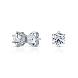 May include: A pair of silver stud earrings with a single round clear stone in each earring.