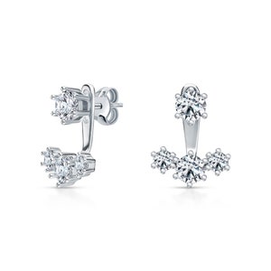 May include: A pair of silver earrings with a single large clear stone on the top and three smaller clear stones on the bottom.