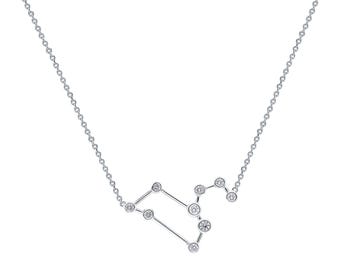 May include: A silver necklace with a constellation design featuring small clear stones. The constellation is Leo.