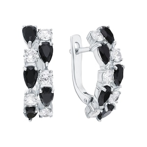 May include: Silver hoop earrings with a row of alternating black and white pear-shaped stones.