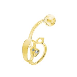 May include: A gold-coloured belly button ring featuring an apple-shaped charm. The apple charm has a heart-shaped cutout and two small, clear gemstones. The ring has a curved barbell design with a ball at the top.