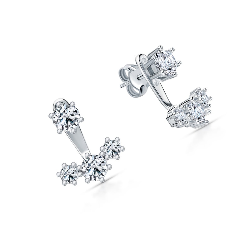 May include: A pair of silver earrings with a cluster of small clear cubic zirconia stones. The earrings are designed to be worn on the upper lobe of the ear.