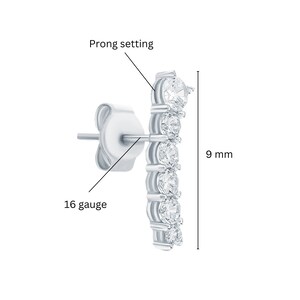 May include: Silver earring with a prong setting and six clear round stones. The earring is 9 mm long and 16 gauge.
