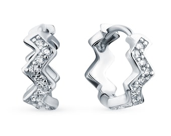 May include: Silver hoop earrings with a zig-zag design and clear cubic zirconia stones.
