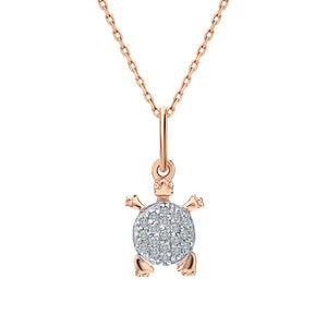 May include: A delicate gold necklace with a small turtle pendant. The turtle is adorned with sparkling white diamonds.