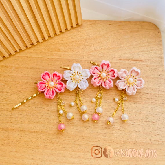 Exquisite Japanese cherry blossom kanzashi hair pins in pink and white, handcrafted traditional hair ornaments perfect for kimono styling and spring seasonal celebrations