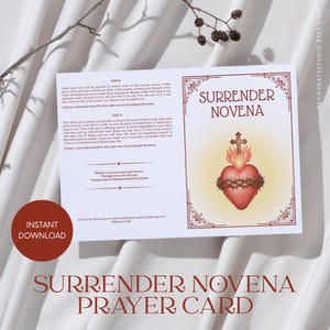 May include: A white prayer card titled Surrender Novena featuring a red Sacred Heart illustration with a cross and crown of thorns. The card includes printed text for Day 8 and Day 9 of the novena, along with a Bible verse from Matthew 11:28.