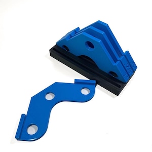 May include: A set of three blue plastic jigs for woodworking, with a black base. The jigs are shaped like a crescent moon and have three holes each. The jigs are labeled "1/2", "3/4", and "1".