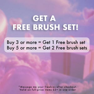 May include: Promotional image with text "GET A FREE BRUSH SET!" against a soft pink and purple sky background. The text offers free brush sets with purchases of 3 or more or 5 or more items. A gift box and heart shapes are also visible.