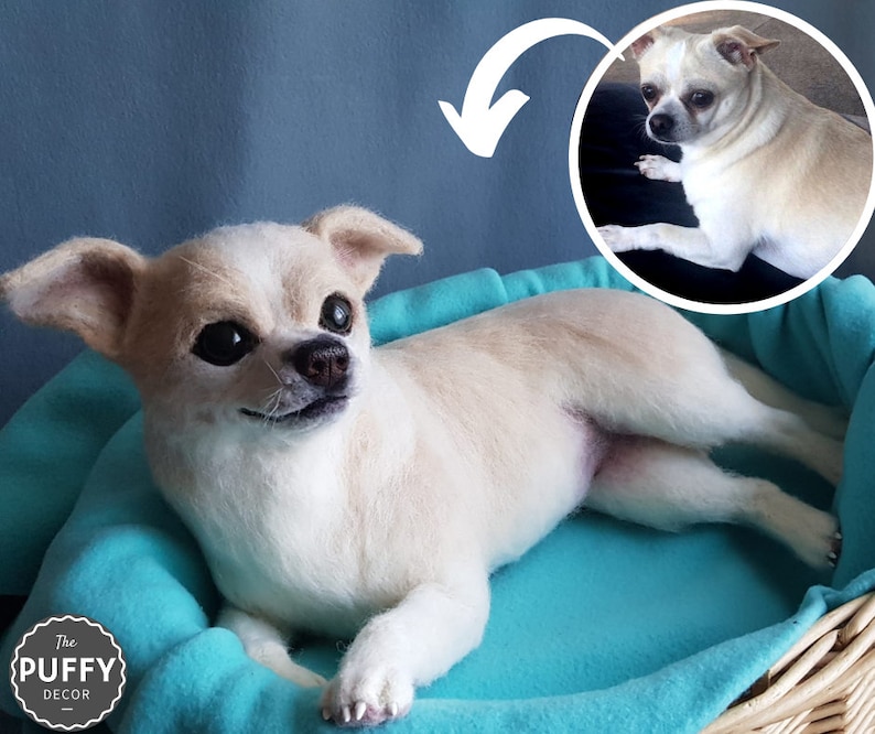 May include: A cream-coloured Chihuahua dog sculpture, lying in a turquoise bed. The dog has dark eyes and a small, black nose. The bed is inside a woven basket. A smaller, circular image of the dog is in the upper right corner. The logo "The Puffy Decor" is in the lower left.