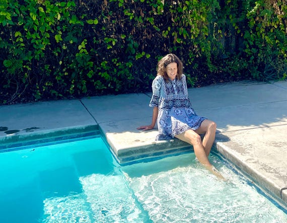 Mbawa (Pool) Cover-Up Dress handmade using the Zanzibar Kanga. Each Kanga contains a S-wahili message for translation.