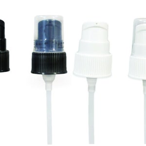 May include: Four different plastic pump bottles with clear tubes. The bottles are black, white, and clear. The pumps are all different styles.