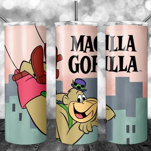 May include: A set of three stainless steel tumblers with a pink background and a cartoon image of a gorilla wearing a hat and swinging from a rope. The text "Macilla Gorilla" is printed on the tumbler.