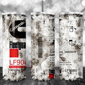 May include: A white tumbler with a distressed, weathered look. The tumbler features a black and red Cummins Fleetguard logo with the text "LF908 Extended Service Li Cummins 286" and "LF9080".