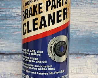 May include: A rusty-looking can of Lucas Oil Products Non-Chlorinated Brake Parts Cleaner. The can is blue and white with a red stripe and features a picture of a brake rotor. The text on the can reads "Lucas Oil Products Inc. Non-Chlorinated Brake Parts Cleaner". The can is sitting on a black surface.