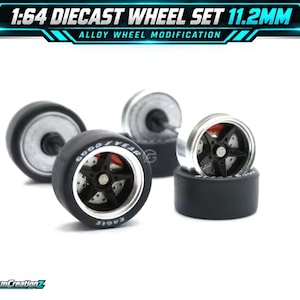 May include: A 1:64 diecast wheel set measuring 11.2mm, featuring black five-spoke alloy wheels with silver rims, red brake calipers, and black tires with white Goodyear Eagle lettering. The text 1:64 DIECAST WHEEL SET 11.2MM is visible.