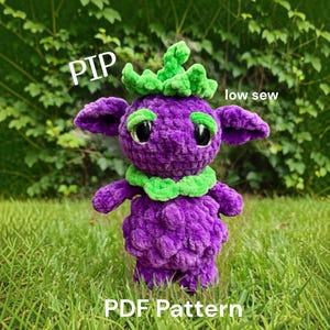 May include: A purple crochet plush toy with a green leafy headpiece and collar, large black eyes, and green eyebrows. The text PIP, low sew, and PDF Pattern is visible on the image. The plush has a textured, soft yarn appearance.