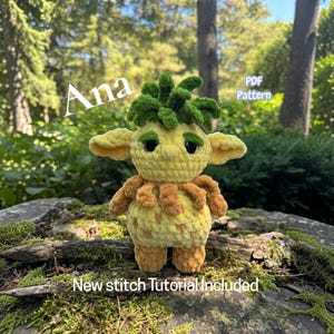 May include: A crocheted plush creature with a yellow body, brown textured accents, and a green leafy top. The text Ana, PDF Pattern, and New stitch Tutorial Included is visible. The creature has large dark eyes, pointed ears, and a round shape.
