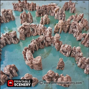May include: A collection of brown, 3D printed rock formations, resembling a miniature island landscape. The rocks are arranged in a circular pattern, creating a maze-like design. The rocks are set against a blue background, suggesting a water setting.