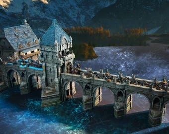 May include: A detailed miniature model of a stone bridge with multiple arches, a tower, and a building. The bridge spans a body of water with a mountainous backdrop. Miniature figures are positioned on the bridge, suggesting a battle scene.