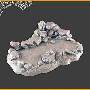 May include: A grey resin miniature of a small pond surrounded by rocks. The pond is shallow and has a rippled surface. The rocks are arranged in a natural-looking way, with some of them forming a small waterfall.