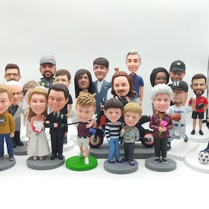 May include: A collection of twenty-one custom bobblehead figurines featuring various individuals in diverse outfits, including a bride and groom, a golfer, a baseball player, and a soccer player, all standing on individual circular bases.
