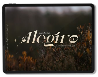 May include: A digital tablet screen displaying the text "introducing Alegiro a beautiful serif font" in a gold serif font against a blurred background of brown and green foliage.