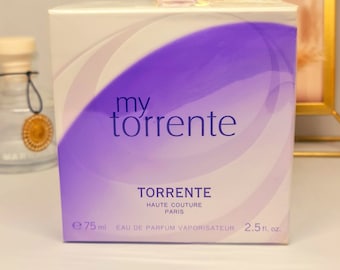 May include: A purple and white box with the text "my torrente" and "TORRENTE HAUTE COUTURE PARIS" on it. The box also says "EAU DE PARFUM VAPORISATEUR" and "2.5 fl. oz."