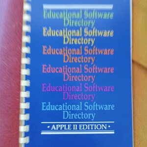 May include: A blue spiral bound book with the title "Educational Software Directory - APPLE II EDITION" printed on the cover.