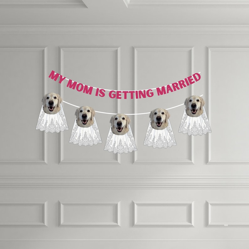 May include: A decorative banner featuring the text MY MOM IS GETTING MARRIED in pink letters. The banner includes five cutouts of golden retriever dog faces, each wearing a white lace veil, strung together on a white cord for display.