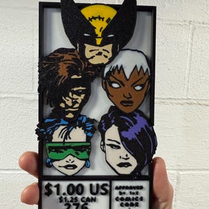 May include: A framed artwork featuring comic book characters Wolverine, Storm, Rogue, and Psylocke. The characters are depicted in a colorful, textured style. The artwork includes text at the bottom, with the words "$1.00 US" and "Approved by the Comics Code Authority."