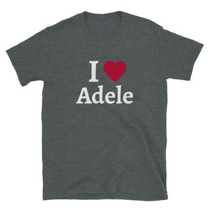 May include: A dark heather grey t-shirt with the text "I ♥ Adele" in white letters with a red heart.