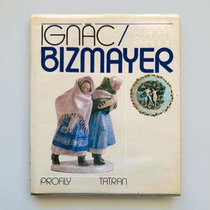 May include: A vintage book cover with the title "IGNAC BIZMAYER" in blue lettering. The cover displays an illustration of two figures in traditional attire and a decorative plate. The words "PROFILY TATRAN" are printed at the bottom.
