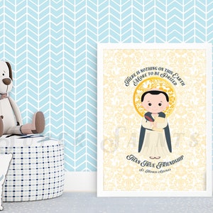 May include: A white framed print with a yellow background and a cartoon illustration of a person in a blue and white robe. The text on the print reads "There is nothing on this earth more to be prized than true friendship - St. Thomas Aquinas".