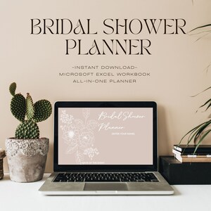 May include: A laptop computer displaying a pink and white bridal shower planner template with a floral design. The text on the screen reads "Bridal Shower Planner" and "(Enter Your Name)".