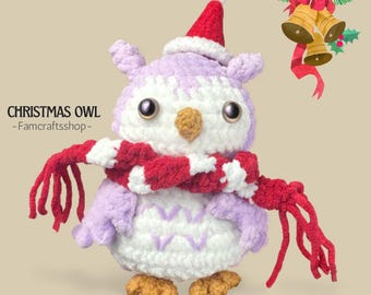 May include: A crocheted Christmas owl in lilac and white, with a red and white striped scarf and a Santa hat. The owl has large eyes and a yellow beak. The text "CHRISTMAS OWL - Famcraftsshop-" is visible. A festive decoration.