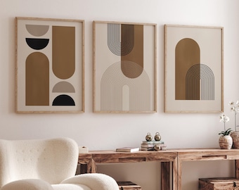 May include: Three framed abstract art prints with geometric shapes in shades of brown and beige. The prints feature arches, circles, and semi-circles.