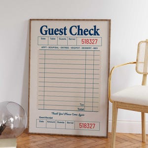 May include: A framed print of a vintage-style guest check. The text "Guest Check" is in navy blue, with a red server number. The check includes sections for date, table, guests, and a detailed list of food and beverage items.