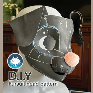 May include: A black and white fursuit head pattern with markings for cutting and sewing. The pattern is on a foam head form with a pink nose.