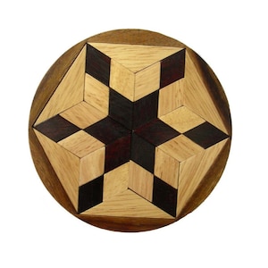 May include: A wooden puzzle with a star-shaped design. The puzzle is made of light and dark wood pieces that fit together to create a geometric pattern.
