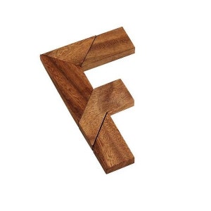 May include: Wooden puzzle in the shape of the letter F. The puzzle is made of multiple pieces that fit together to form the letter.