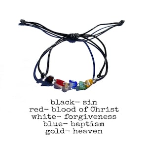May include: A black cord bracelet with six colorful glass beads. The beads are black, red, white, blue, green, and yellow. Text below the bracelet reads: black- sin, red- blood of Christ, white- forgiveness, blue- baptism, gold- heaven.