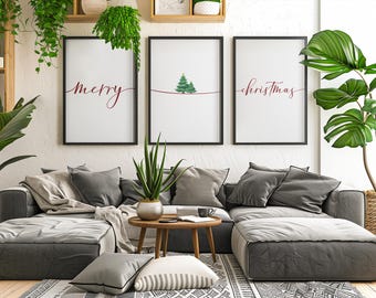 May include: A living room scene with a gray sectional sofa, pillows, and a wooden coffee table. Three framed prints with the words "merry" and "christmas" are displayed. Green plants add a natural touch to the decor.