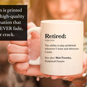May include: White ceramic coffee mug with a black design that reads "Retired: Adjective The ability to play pickleball whenever I want and wherever I want. See also: Matt Parmley, Pickleball Fanatic"