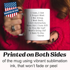 May include: White ceramic mug with black text: "I Came, I Saw, I Forgot What I Was Doing..." and "I Have To Pee." Includes "-Sarah." Printed in the USA. The mug is held against a red background.