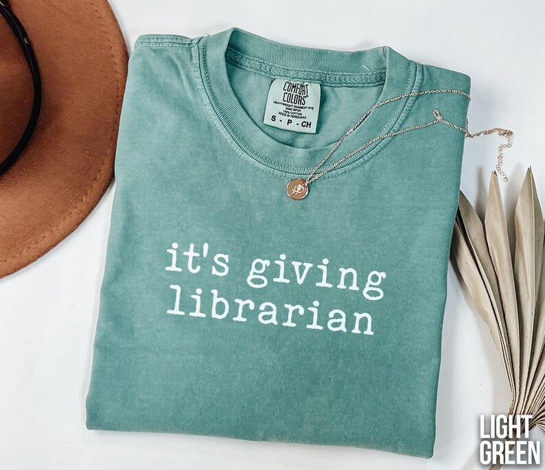 It's giving librarian shirt, light green graphic tee, funny quote t-shirt, book lover gift, librarian appreciation, witty casual top